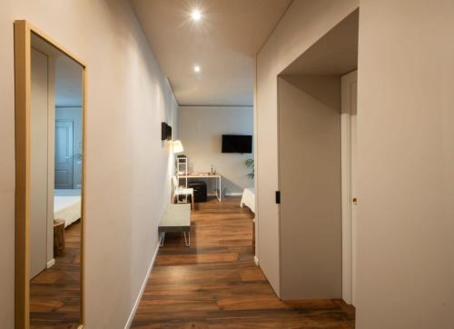 a hallway leading to a room with a bedroom at San Benedetto Rooms in Crema