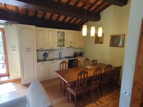 a kitchen with a wooden table and a dining room at Casa Giogo in Arezzo