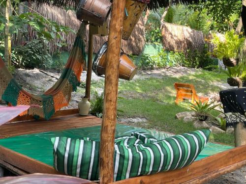 a couple of hammocks on a deck with a yard at Safira Beach House in Pipa