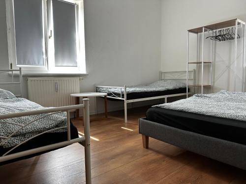 a room with three beds and a window at Ferienwohnung Nahe Schiffshebewerk 