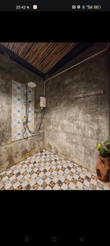 a bathroom with a shower and a tiled floor at Baan Hotelier Resort in Trat