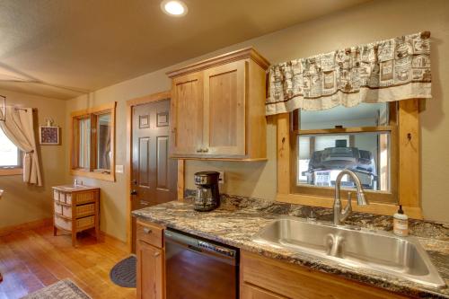 a kitchen with a sink and a window at Cozy Lead Cabin with Deck Less Than 1 Mi to Ski Slopes! in Lead