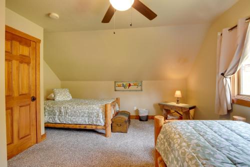 a bedroom with two beds and a ceiling fan at Cozy Lead Cabin with Deck Less Than 1 Mi to Ski Slopes! in Lead