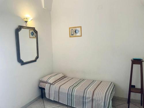 a corner of a room with a bed and a mirror at Victoria Apt - Historical Centre Lecce in Lecce