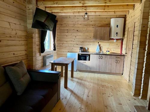 a kitchen with a couch and a table in a room at Family Resort in Mostiska