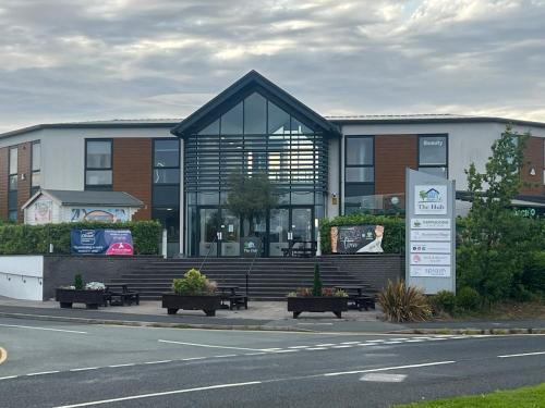 a building with benches and a sign in front of it at Buckshaw Snoozy in Heapey