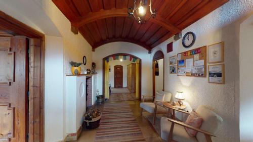 a room with a hallway with a clock on the wall at AlpenRetreat in Nassereith