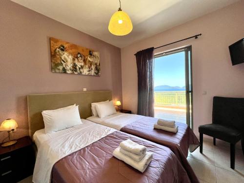 a bedroom with two beds and a window with a view at Villa Nireaus in Chaliotata