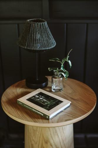 a table with a lamp and a book and a lamp at Bay Point Hideaway in the Woods in Beulah
