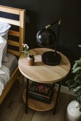 a table with a lamp on it next to a bed at Bay Point Hideaway in the Woods in Beulah