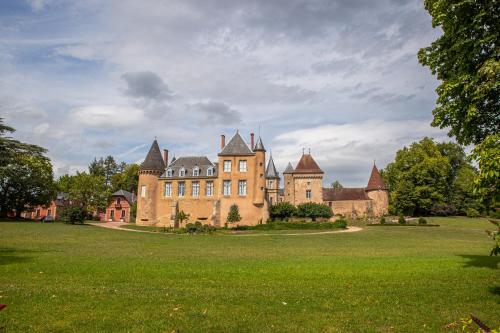 an old castle with a grass field in front of it at Chateau de la Grange in Saint-Émiland