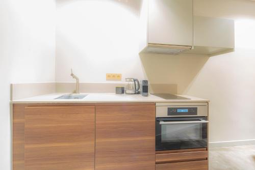 a kitchen with a sink and a stove at Newly build Art Utopia appartment 10min from Rotterdam Central City app1 in Schiedam