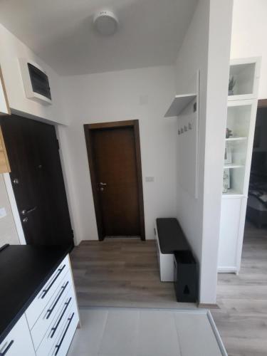 a room with a hallway with a door and a bench at Azur in Jagodina