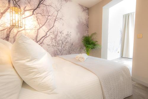 a white bed with a stuffed animal on top of it at Newly build Art Utopia appartment 10min from Rotterdam Central City app1 in Schiedam