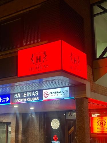 a red sign above the entrance of a building at ALL - Amberstone Lux Loft in Klaipėda