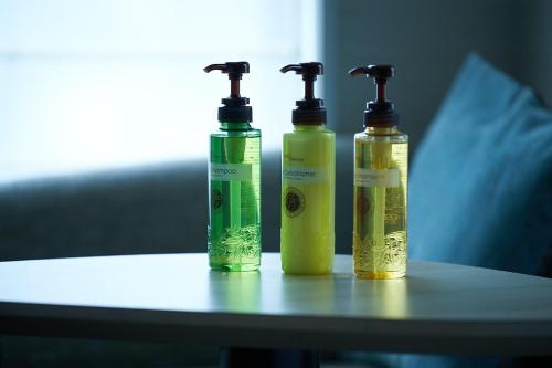 two green and yellow bottles sitting on a table at Hotel Sunroute Ginza in Tokyo