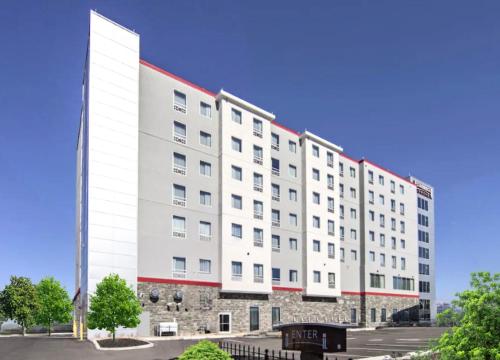 a large white building with a red roof at Staybridge Suites - University Area OSU, an IHG Hotel in Columbus