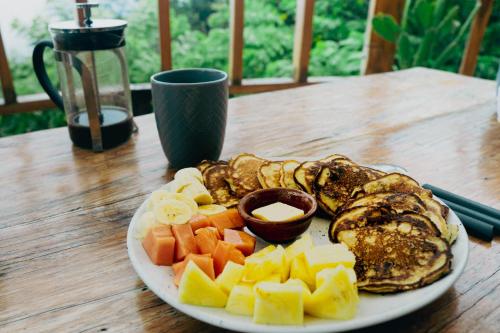 a plate of food on a wooden table at Mountain Nest in Lanquín