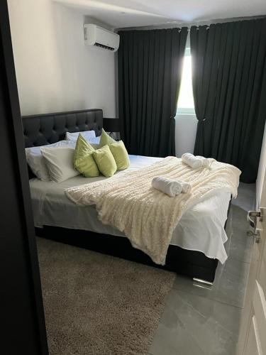 a bedroom with a bed with two towels on it at Neagoe residents in Birkirkara