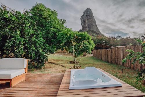 a bath tub sitting on top of a wooden deck at Casa Pé na Areia Noronha in Fernando de Noronha