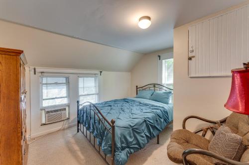 a bedroom with a bed and a window and a chair at Pet-Friendly Home with Views of Lake Delavan! in Delavan