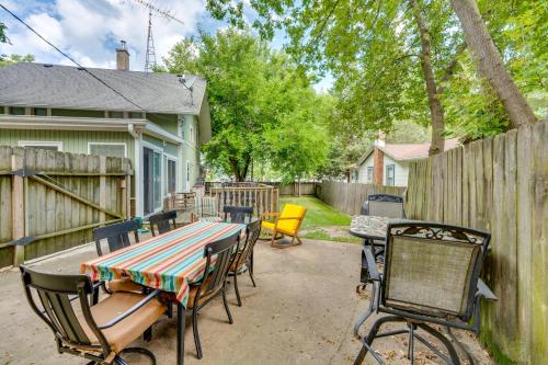 a patio with a table and chairs and a fence at Pet-Friendly Home with Views of Lake Delavan! in Delavan