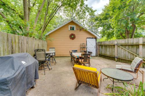 a backyard with tables and chairs and a fence at Pet-Friendly Home with Views of Lake Delavan! in Delavan
