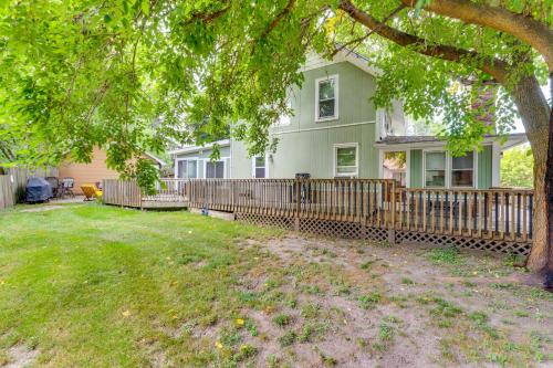 a green house with a wooden fence in a yard at Pet-Friendly Home with Views of Lake Delavan! in Delavan