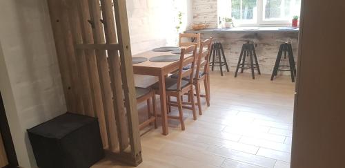 a kitchen with a wooden table and chairs in a room at Dailidžių apartamentai in Klaipėda