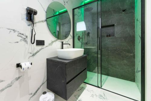 a bathroom with a sink and a shower with a mirror at ML luxury room in Lido di Spina