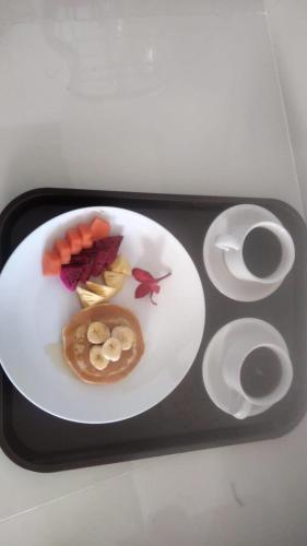 a tray with a white plate with food on it at Comeon Amed in Amed