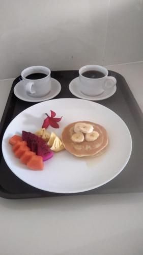 a plate of food on a tray with two cups of coffee at Comeon Amed in Amed