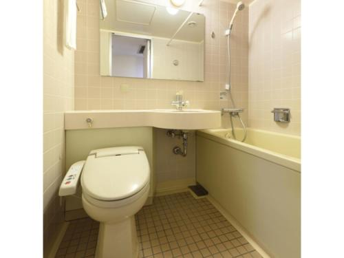 a bathroom with a toilet and a sink and a tub at Misawa City Hotel - Vacation STAY 81780v in Misawa