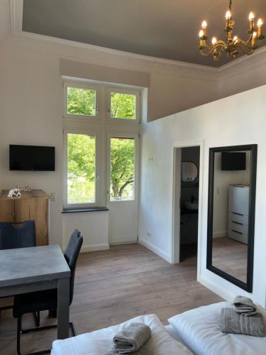 a living room with a table and a mirror at Moseltürmchen Cochem in Cochem