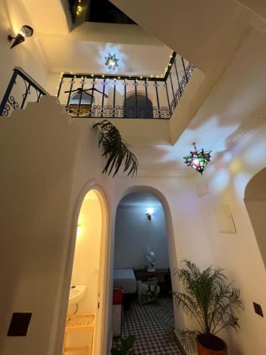 a hallway in a house with a balcony and stairs at Dar Coeur De Tanger - Riad Privé avec terrasse in Tangier