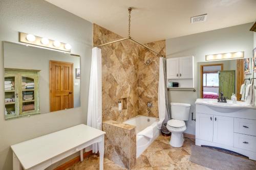 a bathroom with a tub and a toilet and a sink at Mountain Village Home Steps to Ski Lift and Shuttle! in Telluride