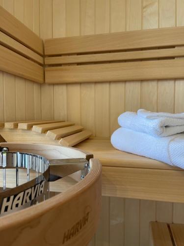 a sauna with towels on a wooden shelf and a towel rack at Eifelsuiten - Suiten mit Sauna, Kamin und Balkon in der Vulkaneifel - Kerpen Loogh in Kerpen