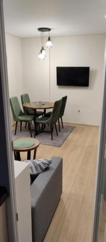 a living room with a couch and a table and chairs at Apartman Vera in Užice