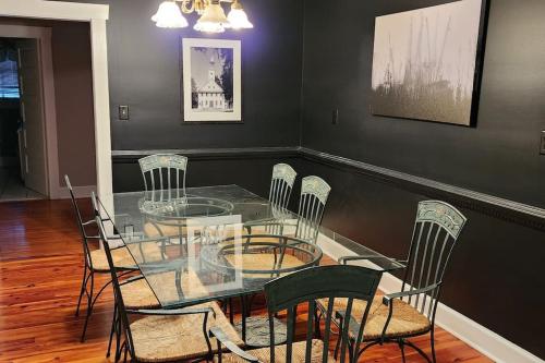 a dining room with a glass table and chairs at A retro rejuvenation in Midway