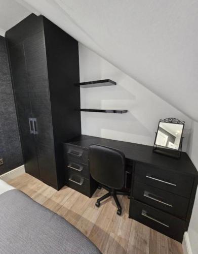 a desk with a mirror and a chair in a room at Luxury Double Room With Private Bathroom in Edinburgh