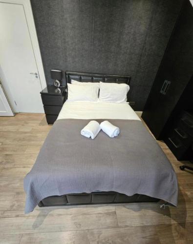 a bedroom with a bed with two towels on it at Luxury Double Room With Private Bathroom in Edinburgh