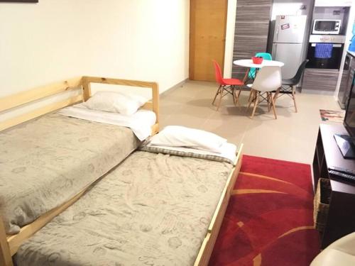 a bedroom with two beds and a table and chairs at APARTAMENT IN PENINSULA IQUIQUE(NEAR OF ALL) in Iquique