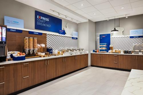 a fast food restaurant with wooden cabinets and a counter at Holiday Inn Express - Strathroy by IHG in Strathroy