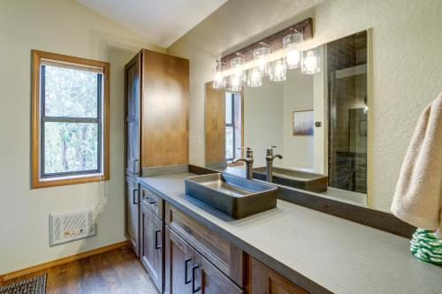 a bathroom with a sink and a mirror at Peaceful Cabin Between Flagstaff and Sedona! in Munds Park