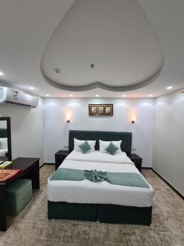 a bedroom with a large bed with a bow on it at فندق زوايا الماسية فرع الحمراء in Al Madinah