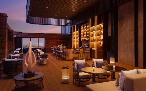 a restaurant with tables and chairs and a bar at InterContinental Tashkent by IHG in Tashkent
