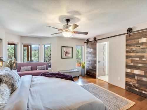 a bedroom with a bed and a ceiling fan at Sedona's Paradise Found, Saltwater Pool and Hot Tub, plus CanAm Ride! in Sedona