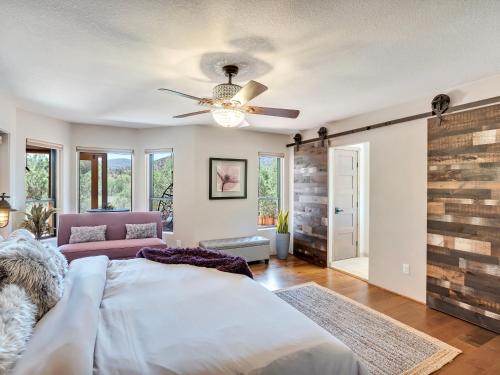 a bedroom with a bed and a ceiling fan at Sedona's Paradise Found, Saltwater Pool and Hot Tub, Private Oasis! in Sedona