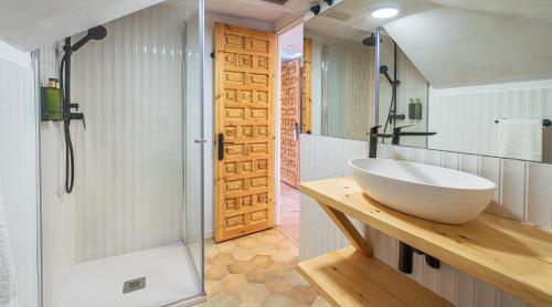 a bathroom with a large white sink and a shower at Hotel BESTPRICE Santillana in Santillana del Mar