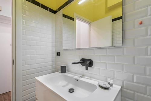 a white bathroom with a sink and a mirror at Easylife - Coccole e relax nel cuore di Isola in Milan